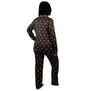 Person wearing a black polka dot pajama set on a white background